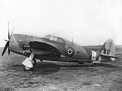 A Royal Air Force P-47 with its raked-forward main gear, and rearward-angled main wheel position (when retracted) indicated by the just-visible open wheel door
