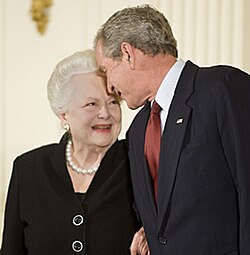 With a glowing smile looking up at the president