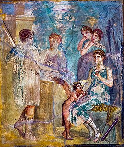 Artemis (seated and wearing a radiate crown), the beautiful nymph Callisto (left), Eros and other nymphs. Antique fresco from Pompeii. National Archaeological Museum, Naples.