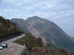 In the distance, Mt. Unzen's Fugen-dake (left) and Heisei-Shinzan peaks, the latter a lava dome that emerged during the 1990–1995 eruption, seen from Nita Pass in November 2005