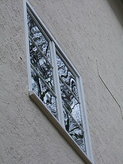 Old window made from soda-lime flat glass, Jena, Germany: The distorted reflections of a tree indicate that the flat glass was possibly not made by the float glass process.