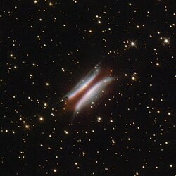 Gomez's Hamburger, with the bright "buns" being the scattered light of the star on the surface of the disk. The reddish dark "patty" represents the mid-plane of the disk.