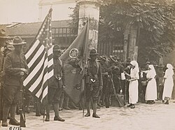 Red Cross nurses serving bread and coffee to American doughboys of the 16th Infantry, 1st Division, upon their arrival in Paris, July 4, 1917