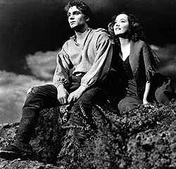 studio still of young man and woman in outdoor setting
