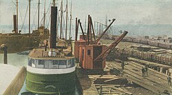 An illustration of iron ore being unloaded at docks in Toledo, Ohio