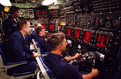 USS Seawolf (SSN-21) Ship Control Panel, with yokes for control surfaces (planes and rudder), and Ballast Control Panel (background), to control the water in tanks and ship's trim