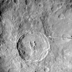 The lunar crater King displays the characteristic features of a large impact formation, with a raised rim, slumped edges, terraced inner walls, a relatively flat floor with some hills, and a central ridge. The Y-shaped central ridge is unusually complex in form.