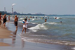 Lake Michigan's beaches, popular with tourists, are juxtaposed with heavy industry.