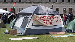 A tent displays a banner saying "Liberated Zone" as protesters occupy Columbia's east lawn, April 17.