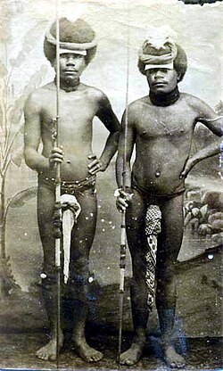 Two Kanak warriors posing with penis gourds and spears, around 1880
