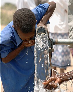 A child drinks water from a well built as part of a hydrogeological humanitarian project in Kenya.