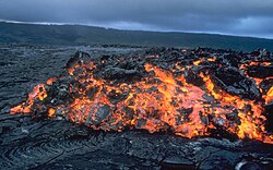 Glowing ʻaʻā flow front advancing over pāhoehoe on the coastal plain of Kīlauea in Hawaii, United States