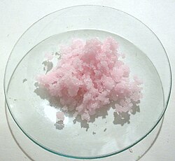 Manganese(II) chloride crystals – the pale pink color of Mn(II) salts is due to a spin-forbidden 3d transition.[27]