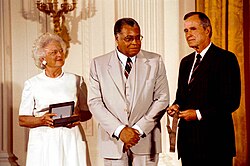 Jones with President George H. W. Bush and First Lady Barbara Bush in 1992, receiving the Medal of Arts