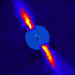 Beta Pictoris with its planet Beta Pictoris b, the light-blue dot off-center, as seen in infrared. It combines two images, the inner disc is at 3.6 μm.