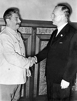 Joseph Stalin and Joachim von Ribbentrop exchanging a handshake after the signing of the Molotov–Ribbentrop Pact in August 1939.