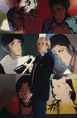 Warhol with portraits from his Athletes series, 1977