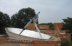 Parabolic dish produces steam for cooking, in Auroville, India.