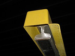 Bottom-contact third rail in a sheath insulator