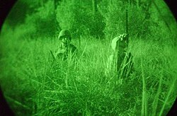 Two American soldiers pictured during the 2003 invasion of Iraq seen through an image intensifier.