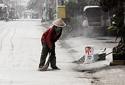 A man sweeping ash from the road in Yogyakarta during the 2014 eruption of Kelud