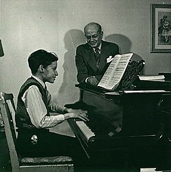Gould with his teacher, Alberto Guerrero, at the Royal Conservatory of Music in Toronto, in 1945. Guerrero demonstrated his technical idea that Gould should "pull down" at the keys instead of striking them from above.