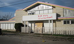 Graffiti on Domino's home from the time he was rumored dead in the aftermath of Hurricane Katrina (2005)