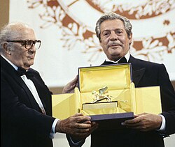 Fellini rewards Marcello Mastroianni with the Golden Lion Honorary Award at the 47th Venice International Film Festival.