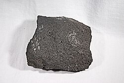 Basaltic andesite lava rock sample from Parícutin, collected from a lava flow, erupted in October 1951, at the base of the volcano's "East Cascade"