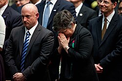 Napolitano stands next to Mark Kelly, husband of shooting survivor Gabby Giffords, at the memorial event.