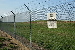 Chain link fence with barbed wire on top