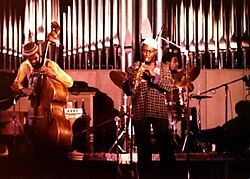 As Coltrane's interest in jazz became experimental, he added Pharoah Sanders (center; c. 1978) to his ensemble.