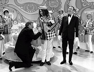 John Wayne and Tiny Tim helped Laugh-In celebrate its 100th episode in 1971.