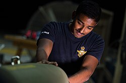 A RAAF armament technician constructing a Joint Direct Attack Munition in 2017
