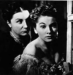 Anderson (left) as Mrs. Danvers terrorizes the second Mrs. de Winter, played by Joan Fontaine (right) in a still from Rebecca.