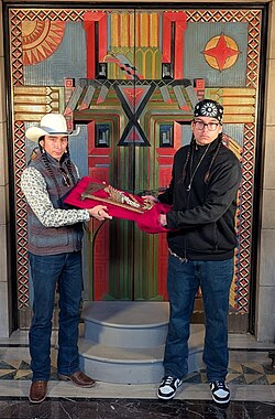Two Ponca tribe men display Chief Standing Bear's pipe tomahawk