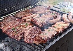 Asado done on a grill using firewood.