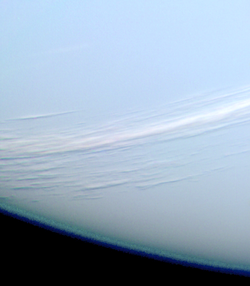 A composite black-and-white photograph showing cirrus clouds over the surface of Mars