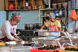 Nyonya cook making various traditional kuih