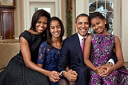 Official portrait by Pete Souza of the Obama family in the Oval Office on December 11, 2011