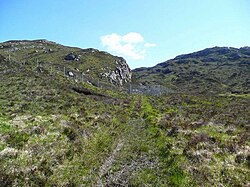 Deer fence and gate on the Tubeg track. This part of the south side of Loch Assynt has been fenced off to assist natural regeneration of the tree cover. So far, there are few trees showing, despite the OS mapping showing this as a wooded area.