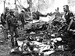 ARVN Forces and a US Advisor inspect a downed helicopter, Battle of Dong Xoai, June 1965