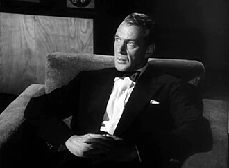 Screen capture of Gary Cooper sitting down