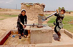 Afghan children near Islamabad fetching water from water pump. (Pakistan once held the second largest refugee population globally after Turkey.[534])