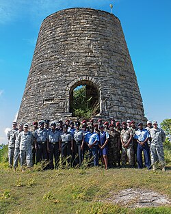 Various members of the national security infrastructure of Antigua and Barbuda posing with the Florida National Guard at a sugar estate
