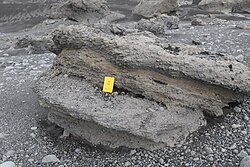 Large slab of rock emerging from rocky ground