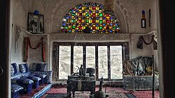 Room inside the Dar al-Hajar near Sanaa, with carved gypsum and coloured glass fanlight