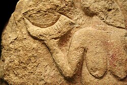 The Venus of Laussel (c. 25,000 BP) holding a crescent shaped horn. The 13 notches on the horn may symbolize the average number of days from menstruation to an ovulation, or the approximate number of full menstrual cycles and lunar cycles per year (although these two phenomena are unrelated).[361][254]