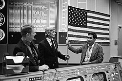 Cernan and Schmitt presenting the flag flown on Apollo 17 to Kranz