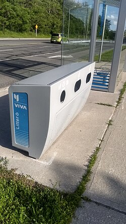 In many places, bus stop infrastructure includes bins for litter. Pictured is a rural bus stop in York Region, north of Toronto.